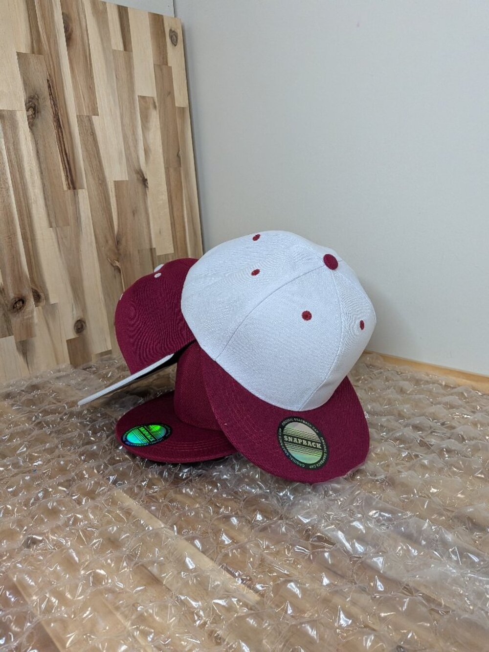 Burgandy and white baseball caps.